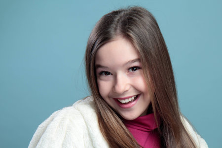 Portrait of a beautiful girl on a blue backgroundの写真素材