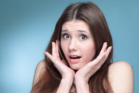 Portrait of a surprised girl の写真素材