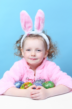 Little, fun girl with bunny ears eggsの写真素材