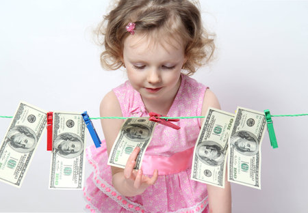 Funny little girl with moneyの写真素材