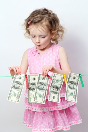 Funny little girl with moneyの写真素材