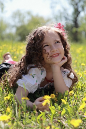Little girl in the Ukrainian national costume on grass.の写真素材