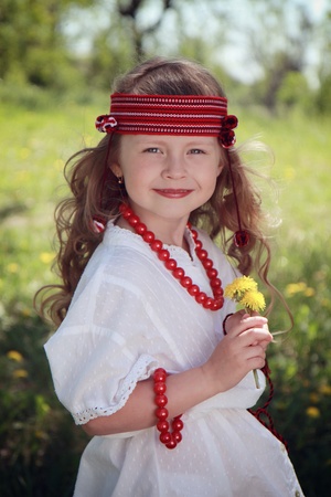 Little girl in the Ukrainian national costume on grass.の写真素材
