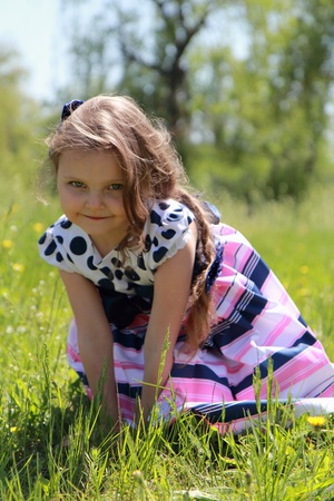 little girl on the grass.の写真素材