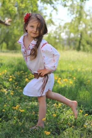 Little girl in the Ukrainian national costume on grass.の写真素材