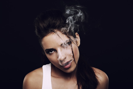 Girl producing cigarette smokeの写真素材