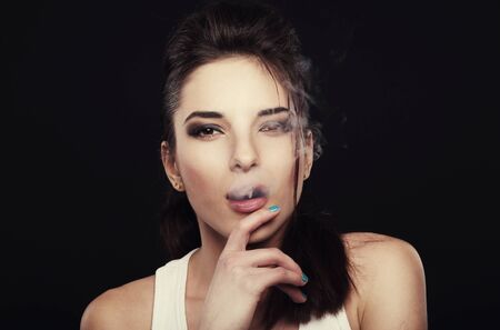 Girl producing cigarette smoke.の写真素材
