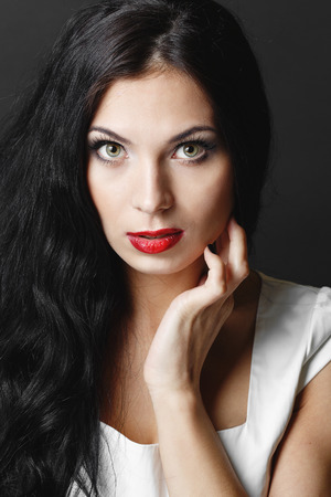 Beautiful woman with curly hair and evening make-up.の写真素材