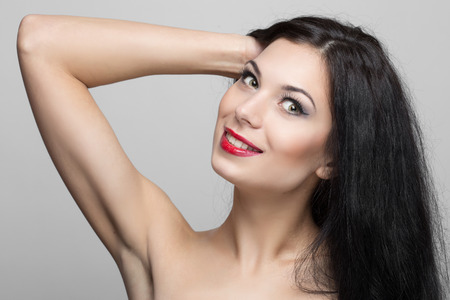 Beautiful woman with curly hair in studio.の写真素材