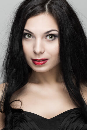 Beautiful woman with curly hair in studio.の写真素材