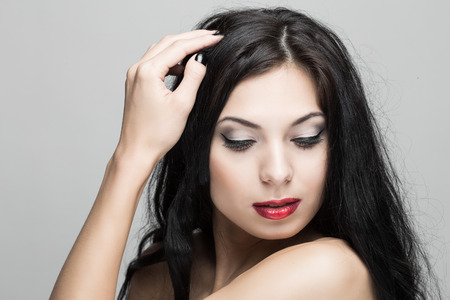 Beautiful woman with curly hair in studio.の写真素材