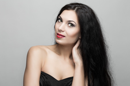 Beautiful woman with curly hair in studio.の写真素材