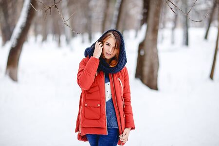 Portrait of a beautiful girl in a winter park. Outdoor.