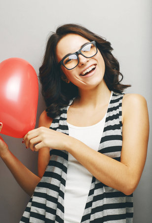 Beautiful girl  holding a heart in his hands.の写真素材