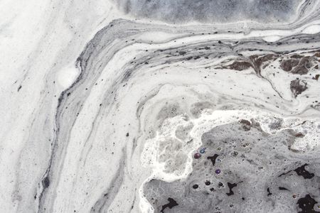 white foam  on  dirty water surfaceの写真素材