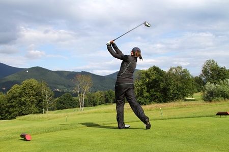 young Girl playing golf -  shooting a golf ballの写真素材