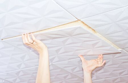 Installation of ceiling tiles made of polystyreneの写真素材