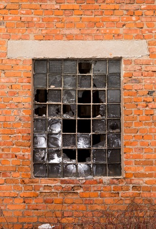 An old brick building with broken windowsの写真素材