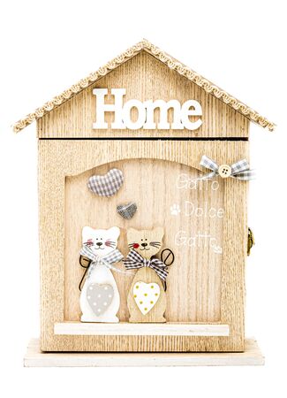 key holder in the form of a house for cats from light wood, key box, the image of two cats, made by hand, interior item, warmth and comfort, isolatedの写真素材