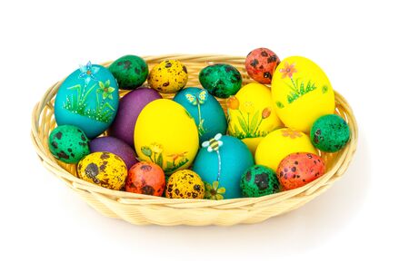 Easter eggs in a wooden basket, beautifully decorated eggs, isolated white backgroundの写真素材
