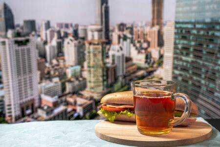 Close up of cup of coffee or tea. New York City panorama is at the background. Concept of business person morning.の写真素材