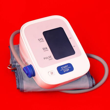 Medical electronic tonometer. blood pressure monitor on blue medical background. Medical concept....