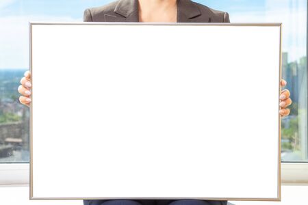 Woman hands holding empty billboard . Mock-up frame