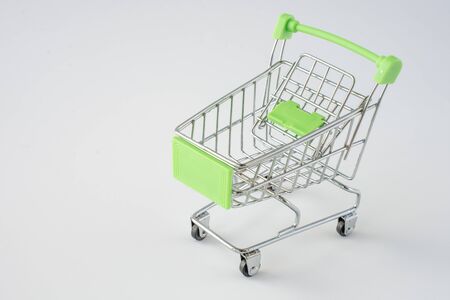 Small shopping cart on gray background. shopping concept. space for textの写真素材