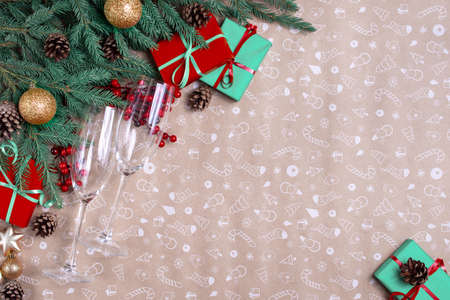Christmas decor on a art paper background. Christmas fir branches, gift boxes with red ribbon, red...