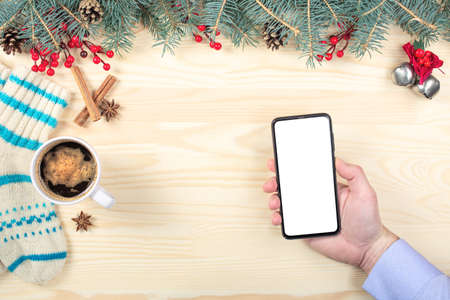 mobile phone mockup on Christmas background. Hand holding blank screen mobile cell phone. mockup...