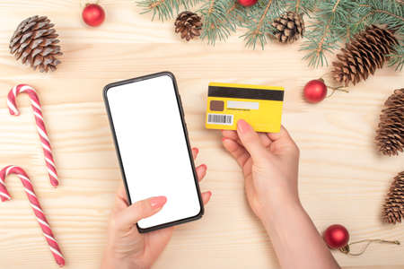 Christmas online shopping concept. Online shopping concept with woman hand using phone and looking...