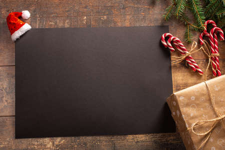 Mockup Christmas greeting card. Christmas And New Year Gifts, Fir Branches And candy canes. Flat Lay Background. wish list or plan for 2021の写真素材