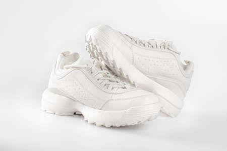 White sneakers on white background. Pair of trendy women's sneakers on white. sports shoes for cold weather. sports shoes conceptの写真素材