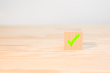 Concept of positive decision making or choice of approval. cross mark x on wooden cube. red cross...