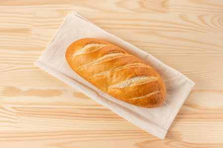 loaf of bread on a wooden table. Fresh bread on wooden table. Top view with space for your text. top...
