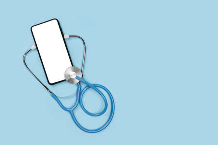 Mockup image medical stethoscope and mobile cell phone with blank screen isolated on blue background. online medicine, doctor online consultation concept. copy spaceの写真素材