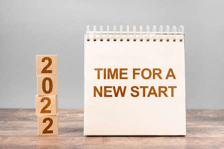 2022 time for a new start. Time for A New Start words and 2022 cubes wooden table background. New Year. startup conceptの写真素材