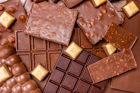 Hazelnut and almond milk and dark chocolate pieces. Delicious chocolate mix. Composition of bars and...