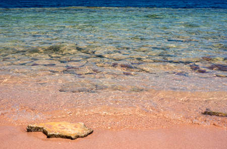 Beach and tropical sea. Close-up soft wave of the sea on the sandy beach. blue sky at the sea. coral beach and blue water in daylight summer hot season in tropical seaの写真素材