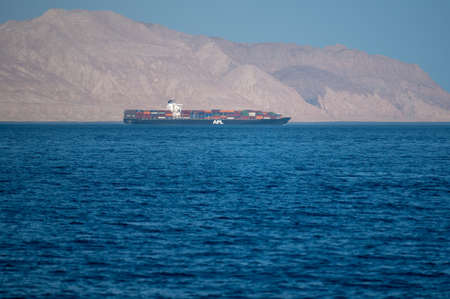 Bukha, OMAN - MAY 28 2021: Iranian coastline near the Strait of Hormuz. giant sea container ship in the strait of Hormuz. Near Eastのeditorial素材