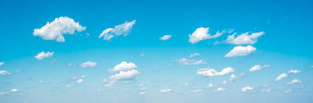 Panorama sky and clouds. White cumulus clouds on clear blue sky background closeup, overcast skies...