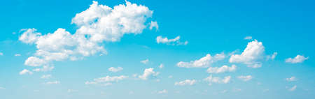 amazing cloud formations on a bright blue sky. beautiful side lit cloudscape panorama in springtime....