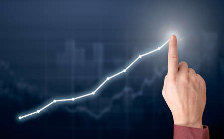 Development and growth concept. Businessman plan growth and increase of positive indicators in his business. hand increase indicators on graph chart. Development and growth concept.の写真素材