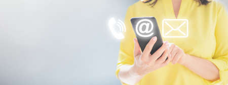 contact us. Close up of women's hands holding cellphone smartphone. Woman holding cell phone with...