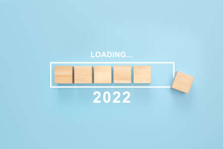 Business concept of planning 2022. Loading new year 2022 wood cube in progress bar. Loading year from 2021 to 2022. New year start conceptの写真素材