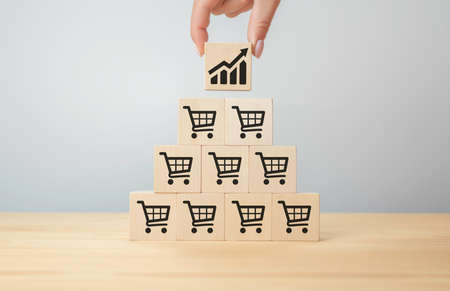 sale volume increase make business grow, Flips cube with icon graph and shopping cart symbol. Retail and Sales growth concept. businesswoman flips cube with icon graph and shopping cartの写真素材