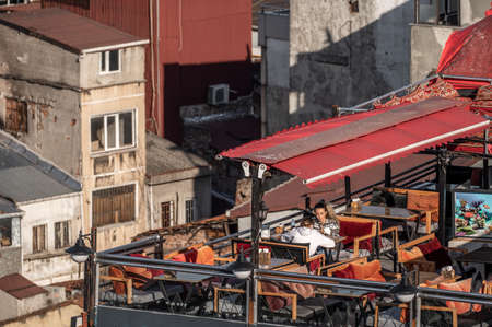 ISTANBUL, TURKEY - OCTOBER 12, 2021: Table setting on roof top restaurant with old building view....
