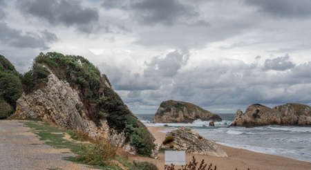 Ocean water splash on rock Peacock beach Turkey with beautiful sky and clouds. Sea wave splashing on stone at sea shore on winter. rocky coastline with white swirling around the rocksの写真素材