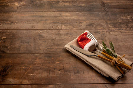 Rustic Table setting. Christmas table place setting. Christmas dinner background. Christmas dinner cutlery on dark old wooden background. copy spaceの写真素材