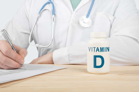Vitamin D and supplements for human health. Doctor recommends taking vitamin D. doctor talks about Benefits of vitamin D. Essential vitamins and minerals for humans. D Vitamin Health Concept.の写真素材